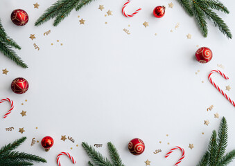 Flat lay New Year composition with fir branches, candy canes, and Christmas balls
