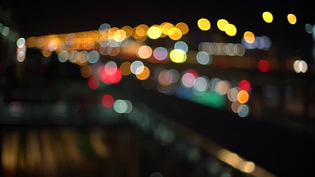The blurred light reflections on the asphalt surface contribute to a smooth and aesthetically pleasing background texture.