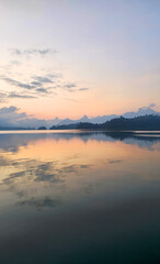 Sunrise reflecting on Cheow Lan Lake, Khao Sok National Park, Ban Ta Khun, Thailand, Southeast Asia.