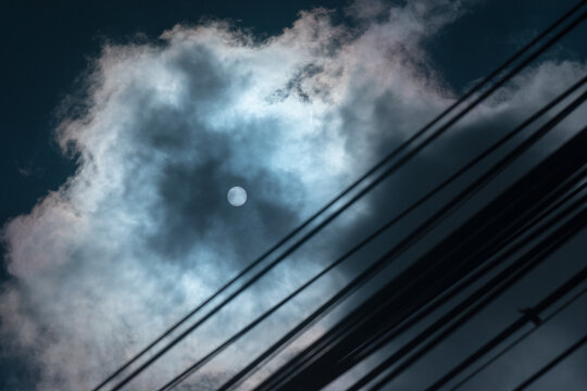 Bright Sun Covered by Clouds and Power Lines. Sun with Cloudy sky dramatic photography - Powered by Adobe
