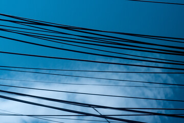 Electric Wires against Blue Sky. Silhouette of Black Electric Wires in the Sky.