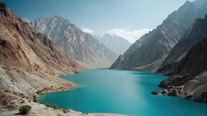 Turquoise lake nestled in a valley framed by towering jagged mountains. Concept Turquoise alpine lake, Valley scenery, Towering jagged mountains, Crystal-clear water reflections