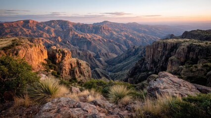 Sunset over a vast canyon with layered red rocks, deep ravines, and desert shrubs in the foreground. Concept Canyon Sunset, Layered Red Rocks, Deep Ravines, Desert Shrubs, Golden Hour Lighting