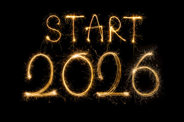Happy New Year 2026. Burning sparkling text 2026 isolated on black background.