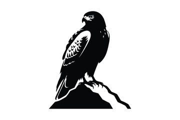 Black silhouette of a majestic hawk perched on a rocky outcrop