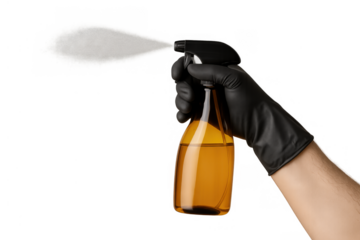 Hand in black glove spraying disinfectant mist from amber bottle, concept for cleaning and hygiene during pandemic