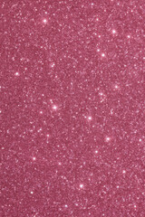 Sparkling pink glitter texture with shimmering highlights creates glamorous luxury background full of bright and festive sparkle