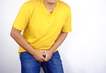 Man holding his groin, Prostatitis Concept, Penile Cancer, Testicular Tumor, young man holding his groin, genitourinary problems, prostate cancer. Man Holding his penis, holding back urine uncontrolla