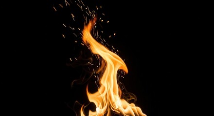 Fototapeta premium Fiery flames dance against the night sky, casting a warm glow and igniting the spirit of adventure