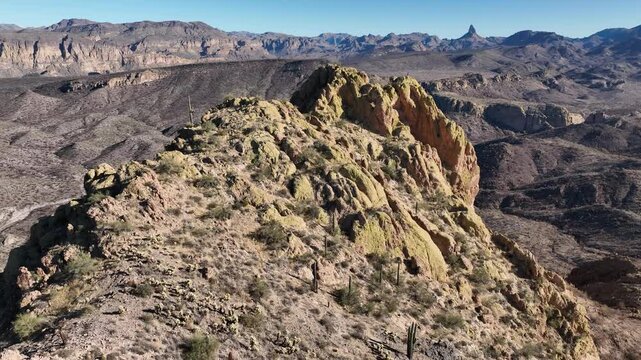 Aerial view of rugged terrain, showcasing a landscape of mountains and valleys under a clear sky, Apache Junction, Arizona, United States.