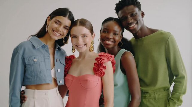 Video of happy diverse young people with wearing clothing of various colors and smiling to camera showing good relationship.Slow motion.AI Generative.
