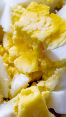 chicken egg cut into small cubes on a brown board