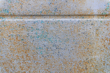 A fragment of an old gray metal wall with cracked paint. A stiffening rib is present. Background. Texture.