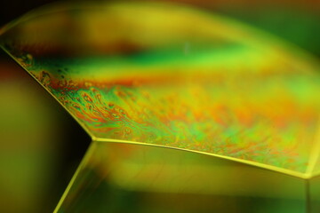 Green liquid surface, minimalistic structure, green oils on a dark background, colourful abstract, surrealistic art, iridescent effect