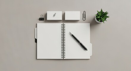 Minimalist workspace with an open blank notebook, pen, and office supplies for productivity and