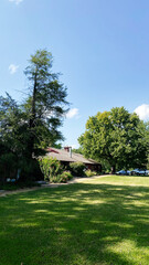 Fototapeta premium Sunny day at a Southern Illinois home with large trees, green lawn, and peaceful yard