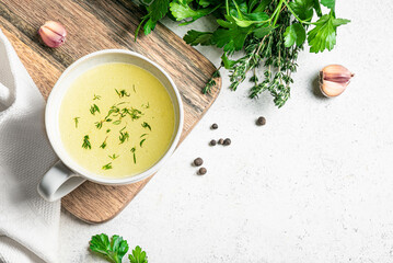 Hot healing bouillon (chicken bone broth) in mug
