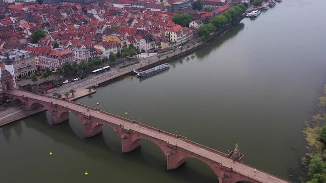 Aerial view of the sandstone Alte Brucke crossing the Neckar River with the city of Heidelberg nestled behind, Baden-Wurttemberg, Germany.