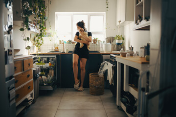 Mother with baby in kitchen