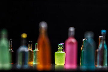 various miniature bottles of alcohol without labels with black bacground