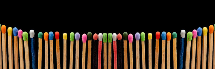 a close-up of wooden matchsticks with vibrant on black background