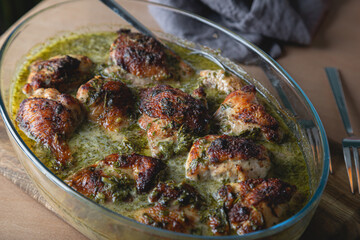 Baked chicken pieces in a creamy sauce with aromatic herbs