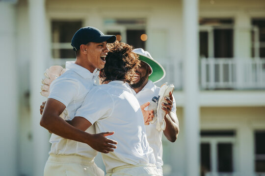 Teammates celebrating together after achieving a winning moment in cricket