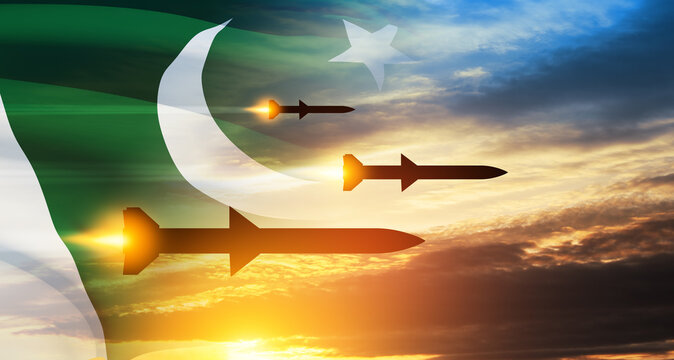Fired missiles fly to the target. Missiles at the sky at sunset with Pakistan flag. Missile defense, a system of salvo fire.