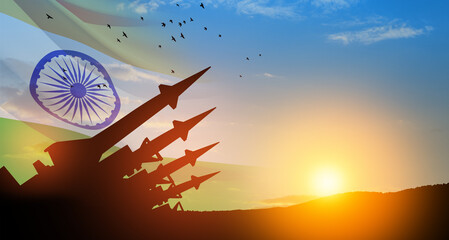 The missiles are aimed at the sky with birds at sunset with Indian flag. Nuclear bomb, chemical weapons, missile defense, a system of salvo fire.