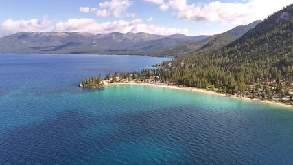 Aerial view of the crystal-clear waters meeting the sandy shorelines and lush forests, a tranquil scene of natural beauty, Sand Harbor, Nevada, United States.