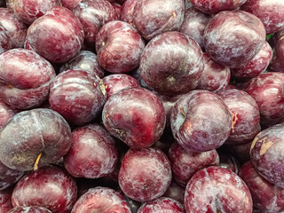 Close-up Pile of Fresh Dark Red and Purple Plums Fruit Texture