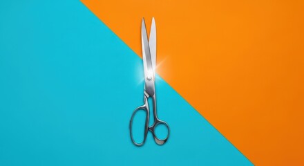 Shiny metal scissors cutting through a vibrant orange and blue background
