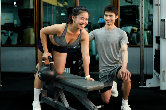 gym sport fitness exercise health woman weight training kettlebell trainer coach instructor personal equipment strong healthy fit active workout body man activity