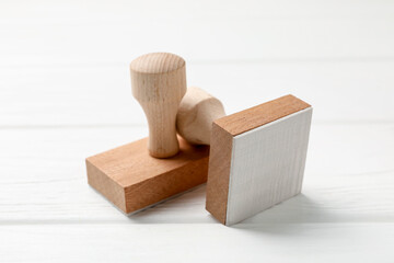 Two wooden stamps on white table, closeup