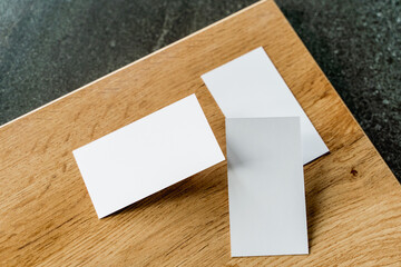 Business card mockup on wooden boards and stone surface
