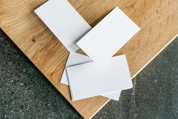 Business card mockup on wooden boards and stone surface
