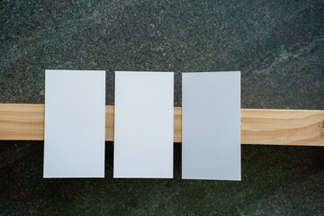 Business card mockup on wooden boards and stone surface
