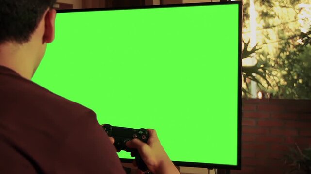 Gamer Playing With Controller in Front of Green Screen TV, Indoor Scene - Close Up - Authentic Footage, Not AI-Generated - 4K