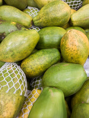 Fresh papayas stacked on a market stall