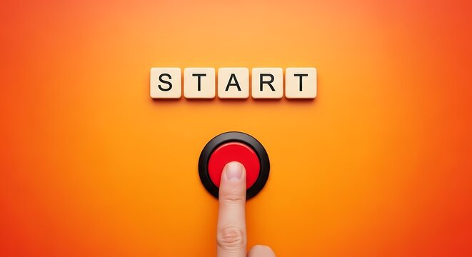 Finger pressing a red start button on an orange colored surface
