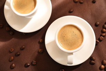 Aromatic coffee in cups and beans on table, flat lay