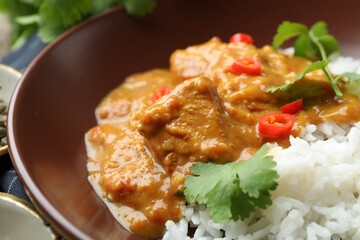 Chicken tikka masala with rice served on table, closeup