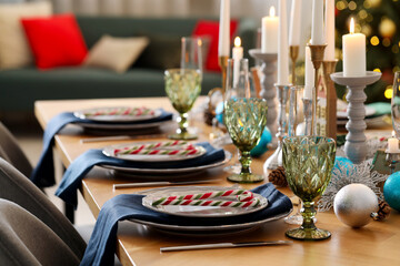 Festive table setting with Christmas decor at home, closeup