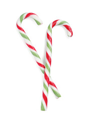 Tasty candy canes isolated on white, top view. Christmas treat