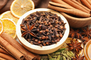 Different spices and dry orange slices for mulled wine on table, closeup
