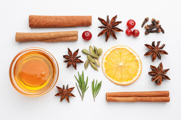 Different spices, cranberries, dry orange slice, honey and fresh rosemary for mulled wine on white table, flat lay