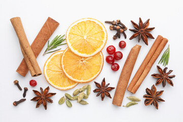 Different spices, cranberries, dry orange slices and fresh rosemary for mulled wine on white table, flat lay