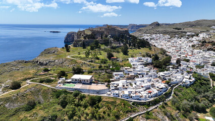 Aerial drone photo of iconic archaeological site of Acropolis of Lindos built uphill featuring...