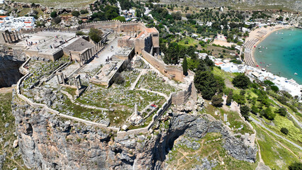 Aerial drone photo of iconic archaeological site of Acropolis of Lindos built uphill featuring...