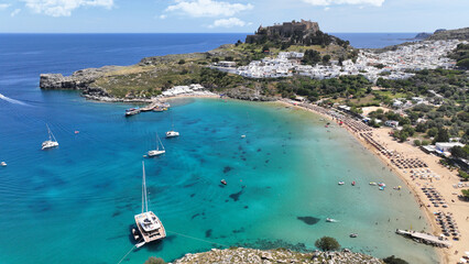 Aerial drone photo of iconic archaeological site of Acropolis of Lindos built uphill featuring...